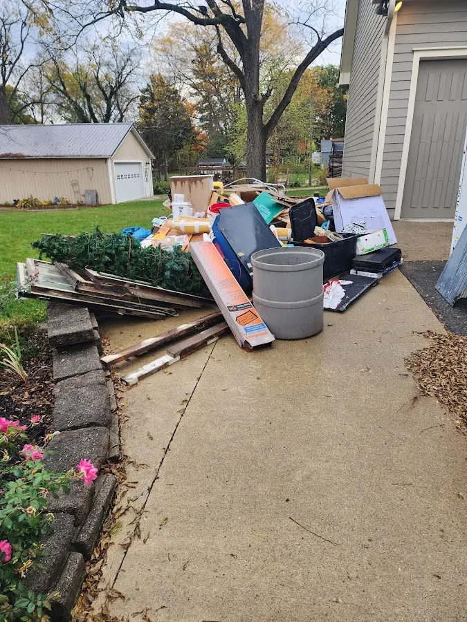 Dumpster being loaded with debris for 10 Yard Dumpster Rental in Columbus